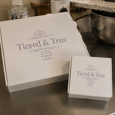 Branded cake boxes with logo on a counter